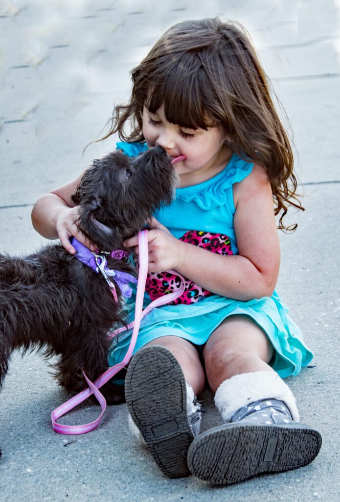 Dogs as early warning systems: A small girl and her guardian dog in a pest-free Dubai home, protected by Eradicators’ eco-friendly pest control services.