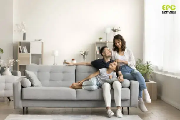 Family relaxing on sofa after professional pest control treatment in Dubai.